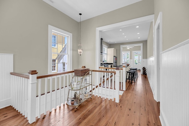 68 Vanderhorst St Unit B, Charleston, SC 29403 - corridor featuring an upstairs landing, light wood-style flooring, wainscoting, and a decorative wall
