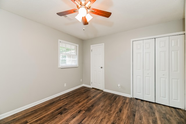 unfurnished bedroom featuring a textured ceiling, ceiling fan, and dark wood-type flooring