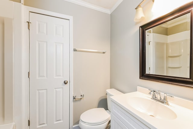 bathroom with ornamental molding, vanity, and toilet