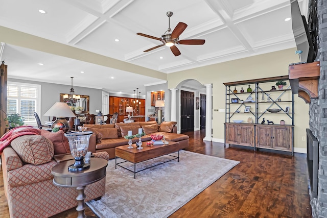 living room with dark wood-type flooring, a fireplace, coffered ceiling, and ornate columns