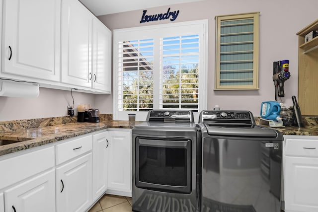 washroom featuring cabinets, washer and dryer, and light tile patterned floors