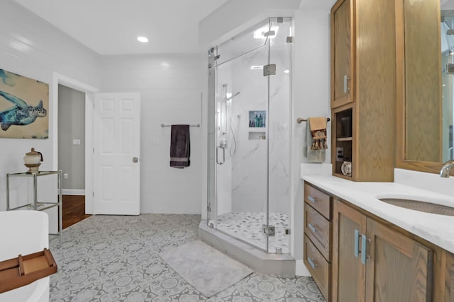 bathroom with vanity and a shower with door