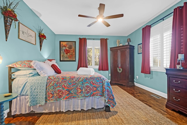 bedroom with ceiling fan and dark hardwood / wood-style flooring