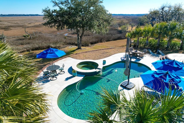 view of pool featuring an in ground hot tub and a patio area