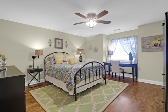 bedroom with dark hardwood / wood-style floors and ceiling fan