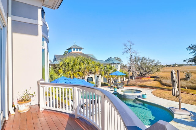 view of pool featuring an in ground hot tub