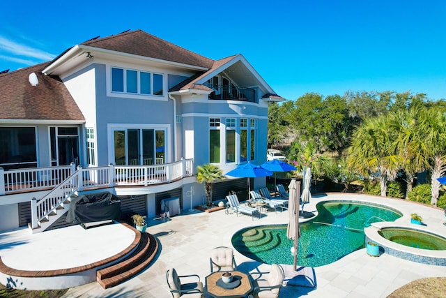 back of house with a pool with hot tub and a patio