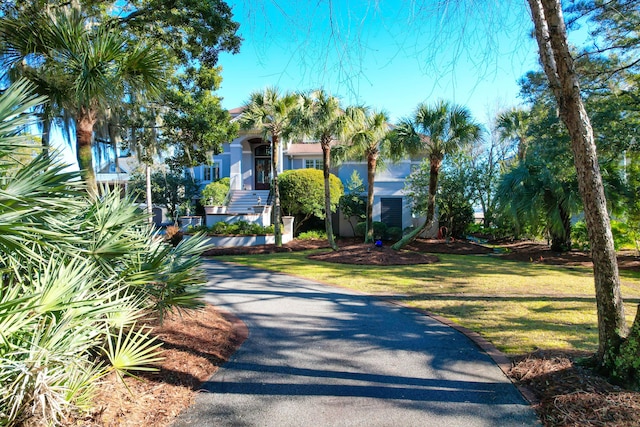 obstructed view of property featuring a front yard