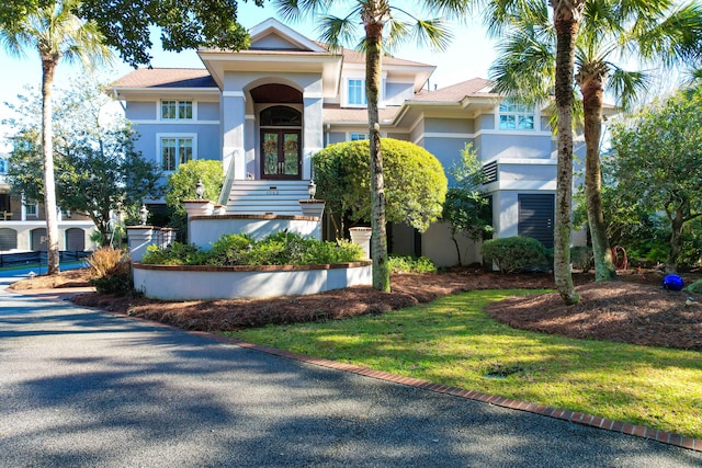 view of front facade with a front yard and french doors