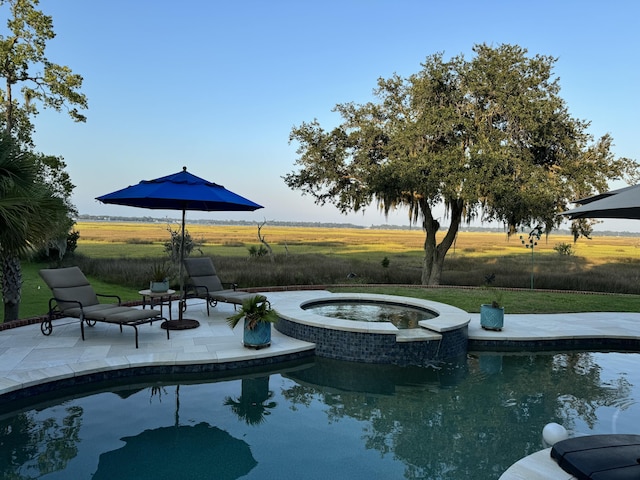 view of swimming pool with an in ground hot tub, a patio, and a lawn