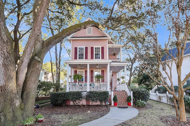 view of front of house with stairs, fence, and a porch