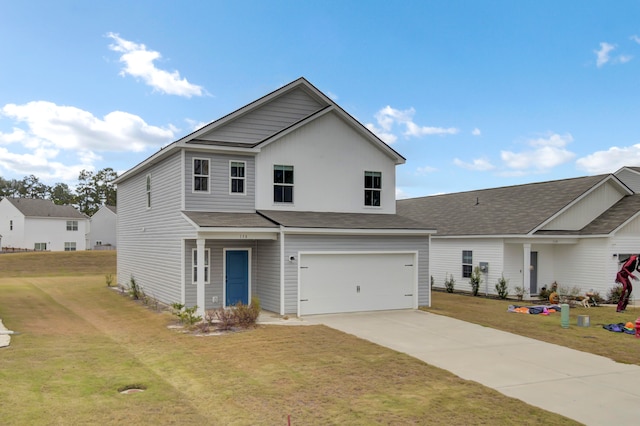 view of property featuring a front lawn and a garage