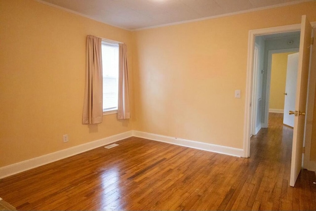 424 Salley Ackerman Dr, Cottageville, SC 29435 - empty room with visible vents, baseboards, crown molding, and hardwood / wood-style flooring