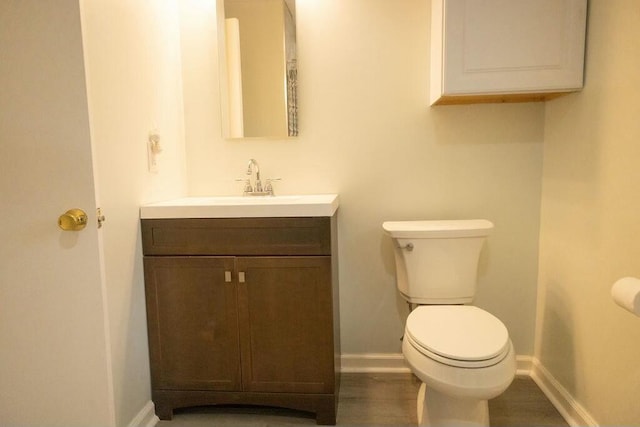 424 Salley Ackerman Dr, Cottageville, SC 29435 - bathroom featuring baseboards, toilet, wood finished floors, and vanity