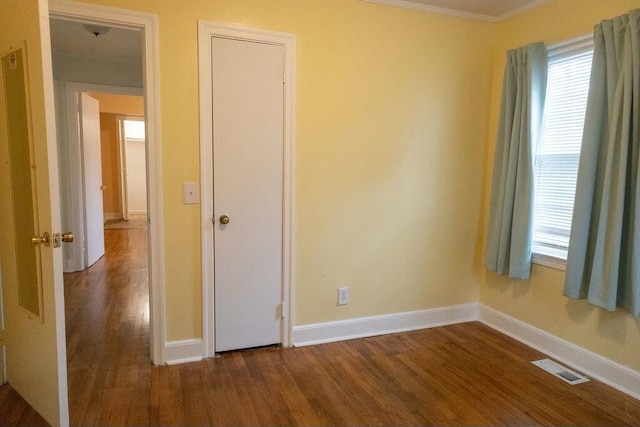 424 Salley Ackerman Dr, Cottageville, SC 29435 - unfurnished bedroom featuring dark wood-style floors, visible vents, baseboards, and ornamental molding