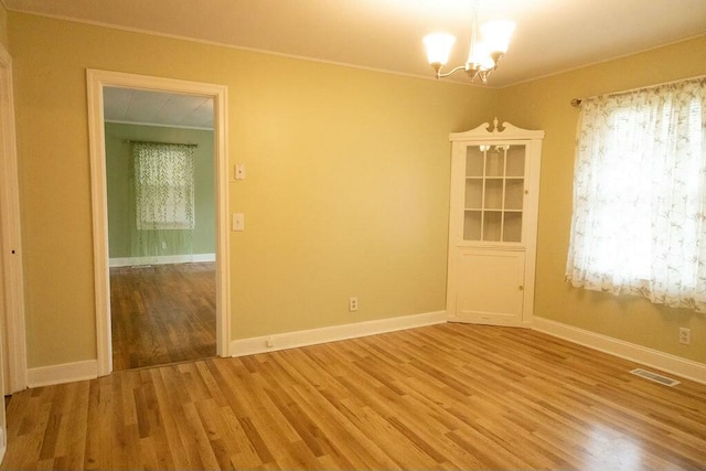 424 Salley Ackerman Dr, Cottageville, SC 29435 - unfurnished room with a notable chandelier, visible vents, light wood-style flooring, and baseboards