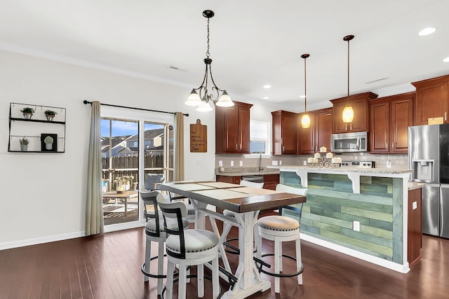 108 Glenspring Dr, Summerville, SC 29486 - kitchen with stainless steel appliances, backsplash, a kitchen breakfast bar, dark wood-style flooring, and crown molding