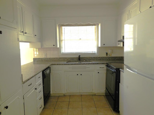 kitchen with sink, backsplash, white cabinetry, and black appliances