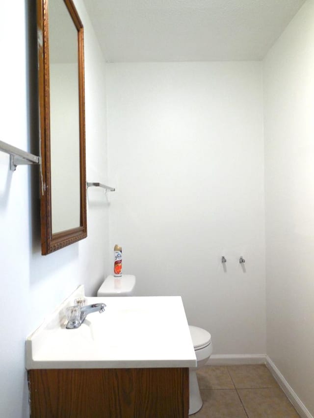 bathroom featuring vanity, tile patterned flooring, and toilet