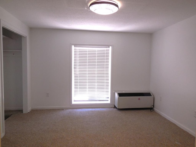 unfurnished bedroom with carpet floors, a closet, and a textured ceiling