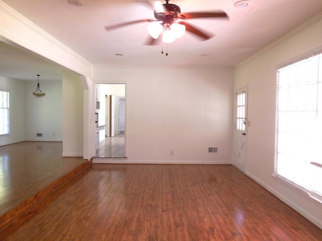 spare room with ceiling fan, ornamental molding, and dark hardwood / wood-style flooring