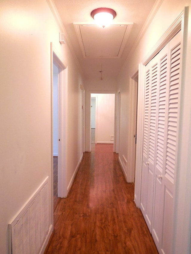 hallway featuring ornamental molding and dark hardwood / wood-style flooring