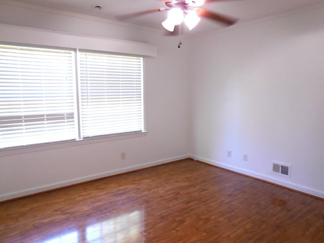 unfurnished room with crown molding, hardwood / wood-style floors, and ceiling fan