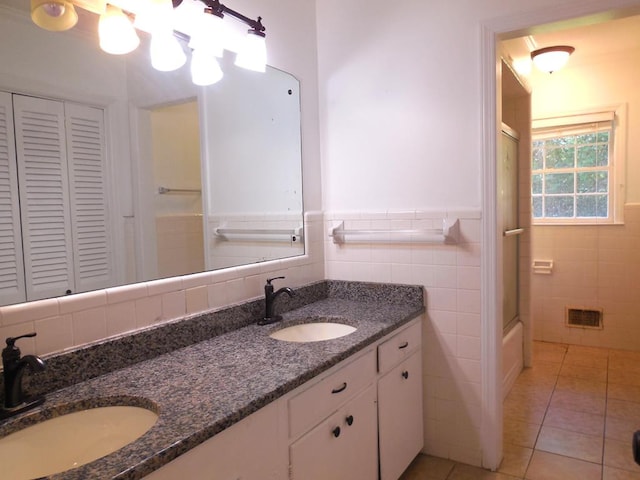 bathroom featuring vanity, tile walls, and tile patterned flooring