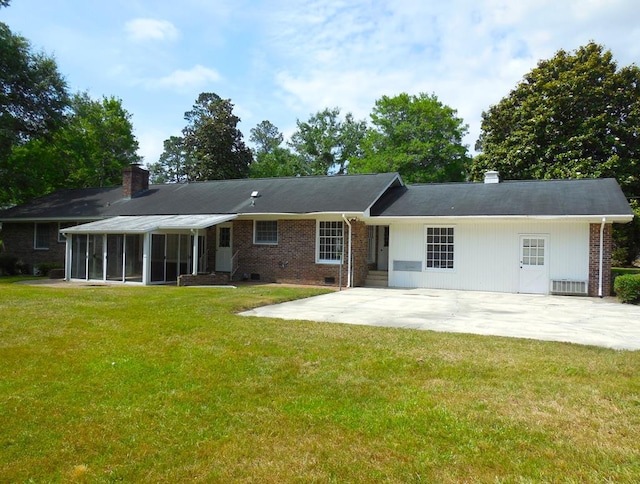 back of house featuring a sunroom, a yard, and a patio