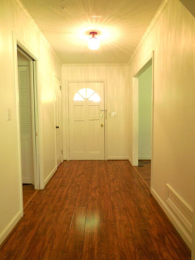 entryway featuring crown molding and dark hardwood / wood-style flooring