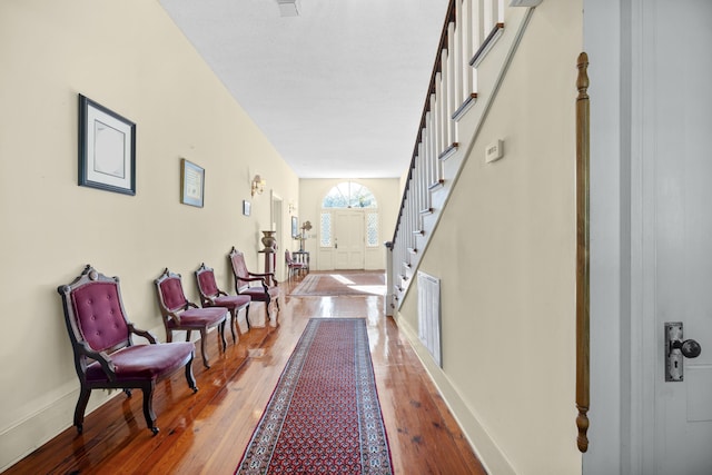 hallway with hardwood / wood-style floors