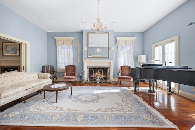 living area with a notable chandelier and wood-type flooring