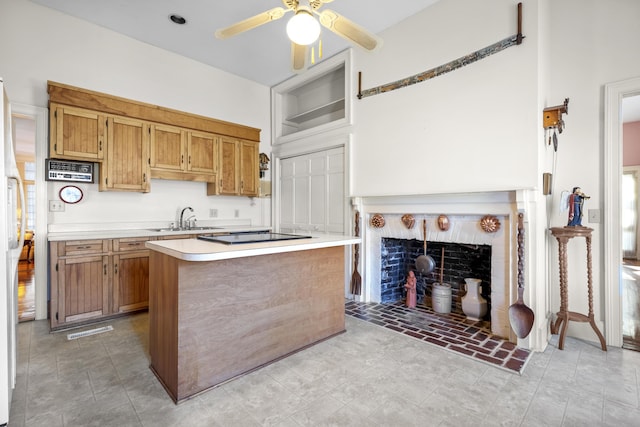 kitchen featuring black electric stovetop, ceiling fan, white refrigerator, a kitchen island, and sink