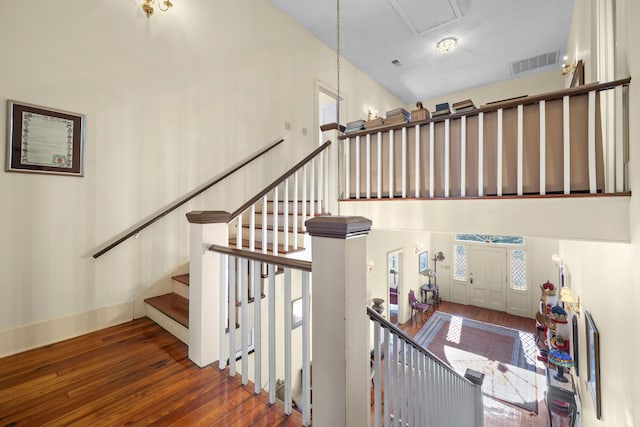 staircase with hardwood / wood-style flooring