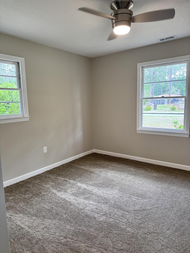 carpeted empty room with a textured ceiling and ceiling fan