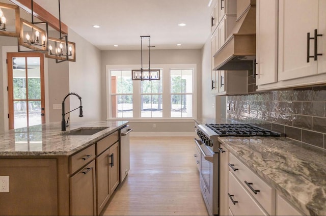 74 Longleaf Dr, Walterboro, SC 29488 - kitchen featuring an inviting chandelier, premium range hood, light wood-style floors, appliances with stainless steel finishes, and a sink