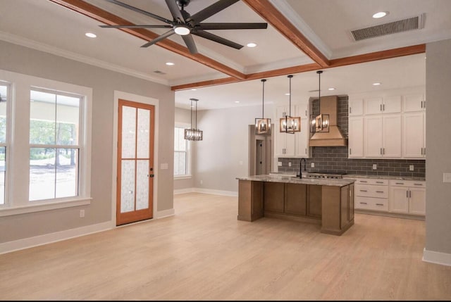 74 Longleaf Dr, Walterboro, SC 29488 - kitchen with custom exhaust hood, crown molding, white cabinetry, and visible vents