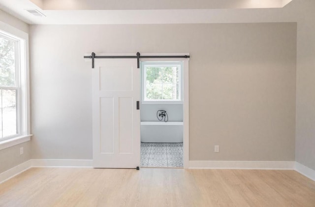 74 Longleaf Dr, Walterboro, SC 29488 - empty room featuring light wood finished floors, baseboards, visible vents, and plenty of natural light