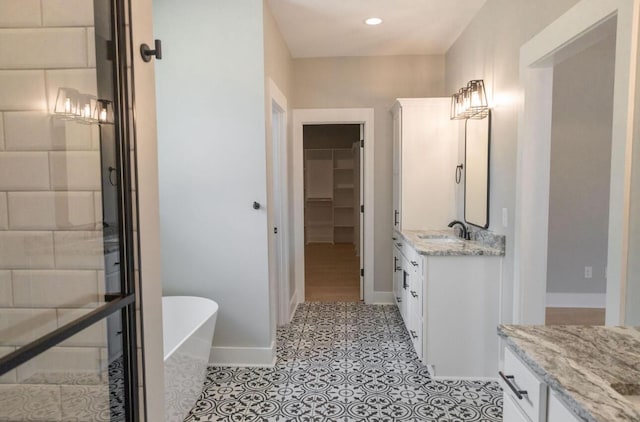 74 Longleaf Dr, Walterboro, SC 29488 - full bath featuring baseboards, a freestanding tub, a walk in closet, recessed lighting, and vanity