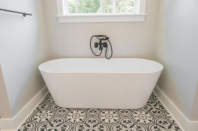 74 Longleaf Dr, Walterboro, SC 29488 - bathroom featuring tile patterned floors, a soaking tub, and baseboards