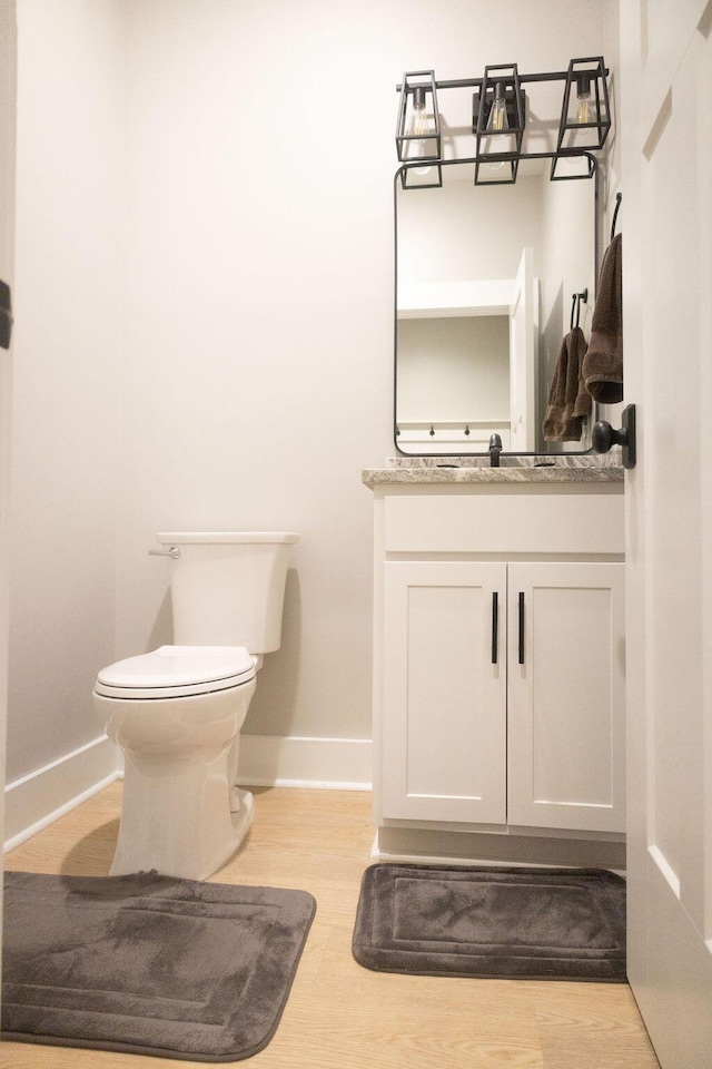 74 Longleaf Dr, Walterboro, SC 29488 - half bath featuring toilet, wood finished floors, vanity, and baseboards
