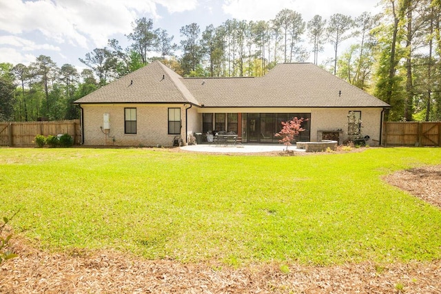 74 Longleaf Dr, Walterboro, SC 29488 - back of house featuring roof with shingles, a patio area, a fenced backyard, and a lawn