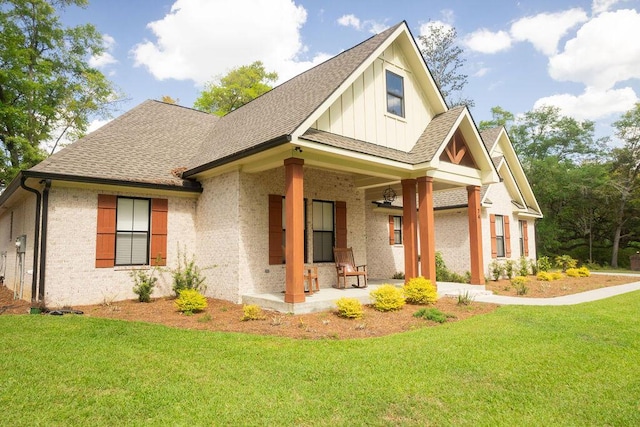74 Longleaf Dr, Walterboro, SC 29488 - view of front of home featuring board and batten siding, a front yard, and a shingled roof