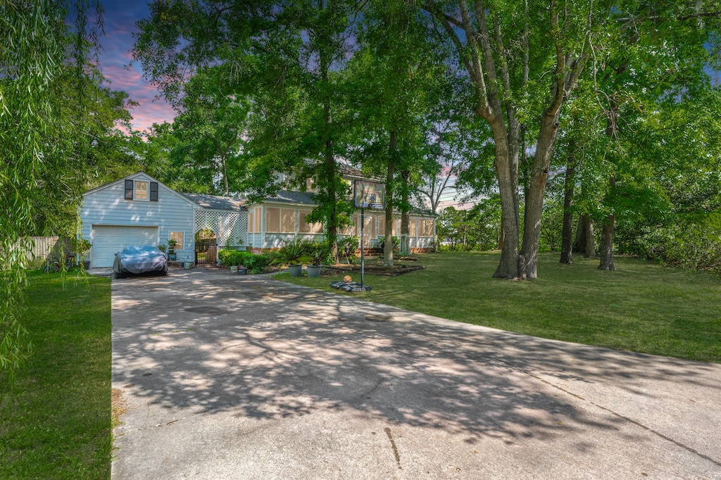 view of front of property featuring a garage and a yard