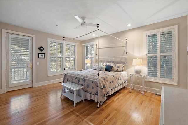 bedroom with light hardwood / wood-style flooring, ceiling fan, access to exterior, and multiple windows