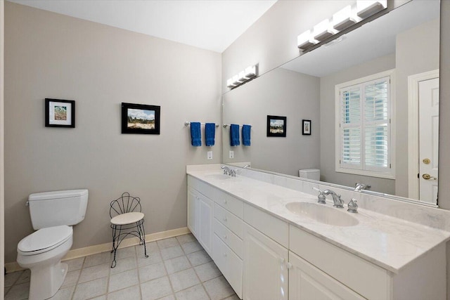 bathroom featuring tile floors, toilet, and double vanity