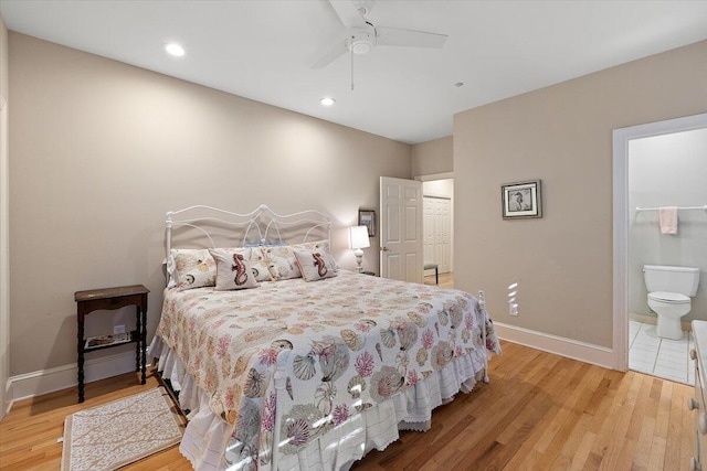 bedroom featuring ensuite bath, ceiling fan, and light hardwood / wood-style flooring