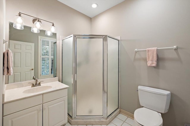 bathroom featuring a shower with shower door, tile flooring, toilet, and vanity