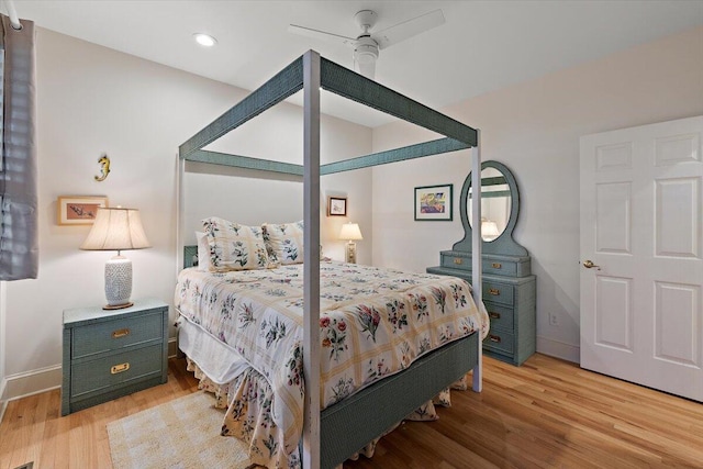 bedroom with ceiling fan and light hardwood / wood-style floors