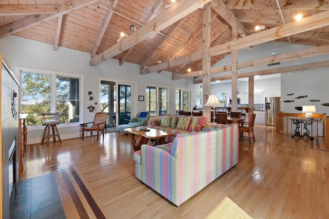 living room with wooden ceiling, high vaulted ceiling, light wood-type flooring, and beamed ceiling